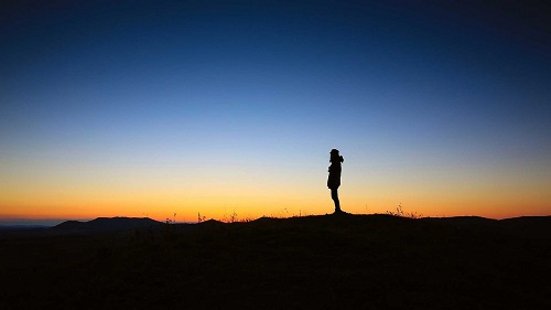 a silethouette of a man at dusk, meditation, peace and solitude